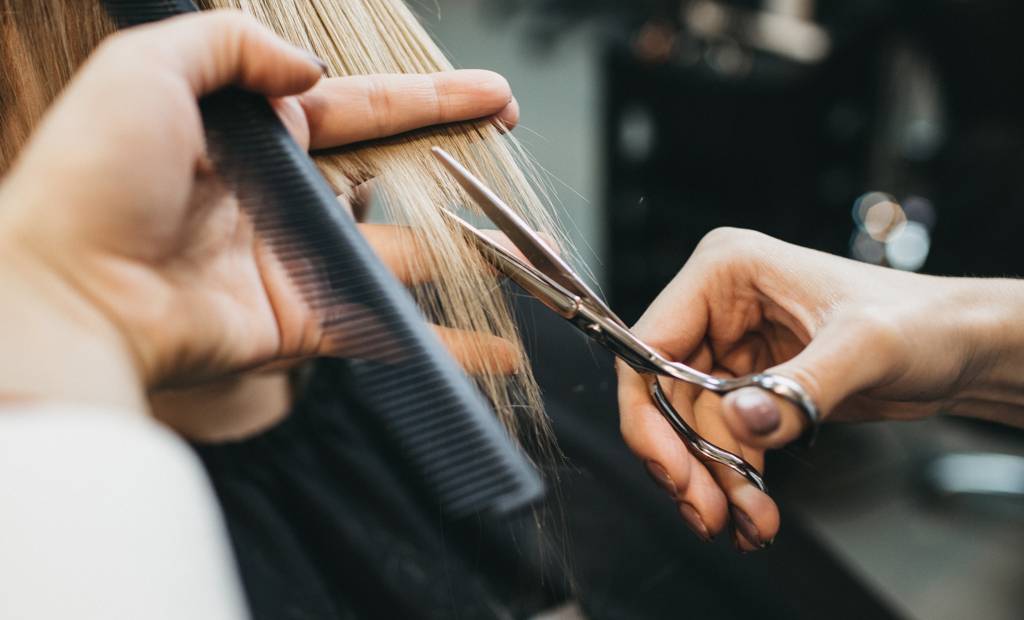 Image d'une coupe en cours avec les ciseaux et un peigne